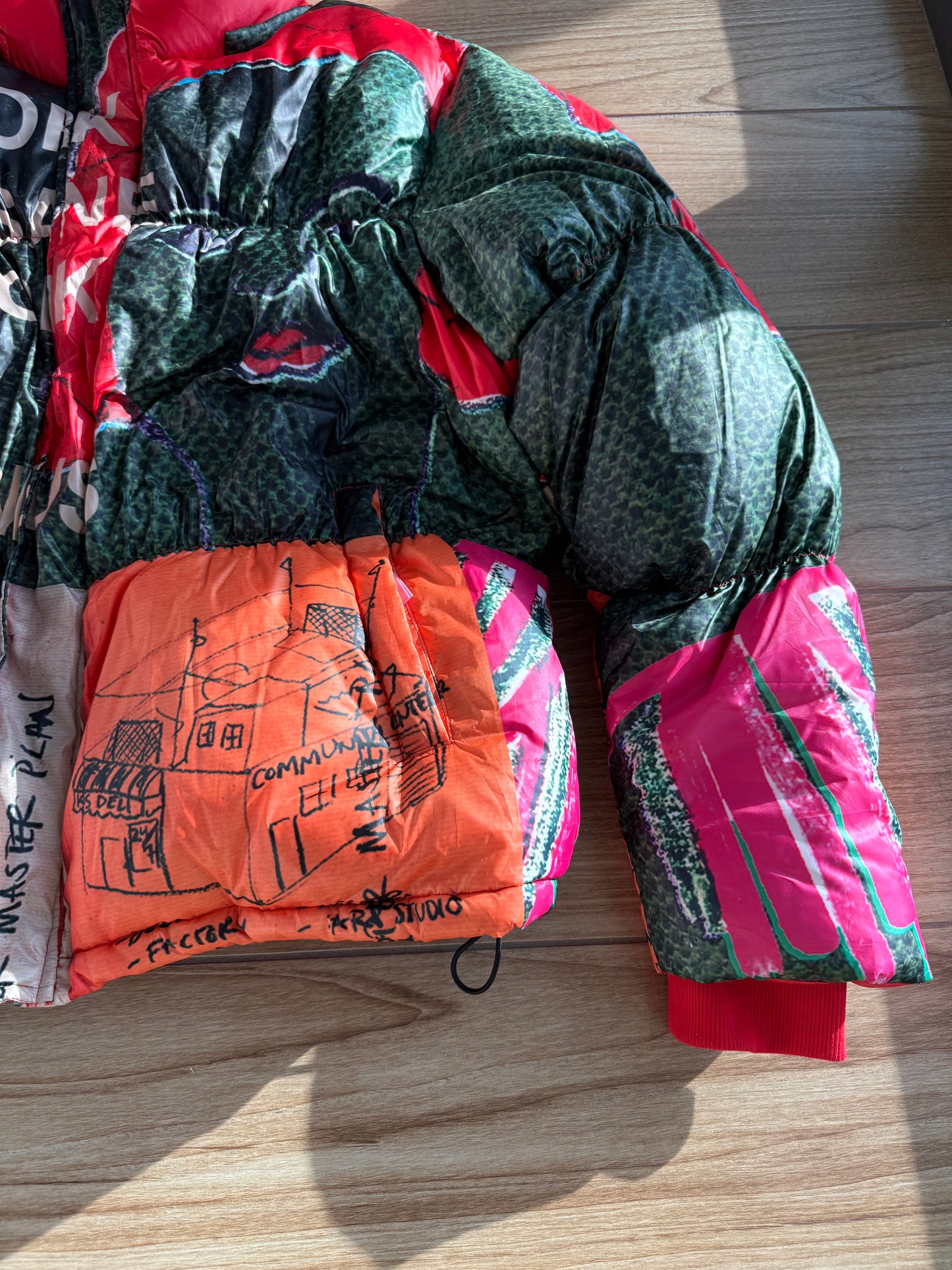KidSuper Studios “Genius Collage” Puffer Jacket