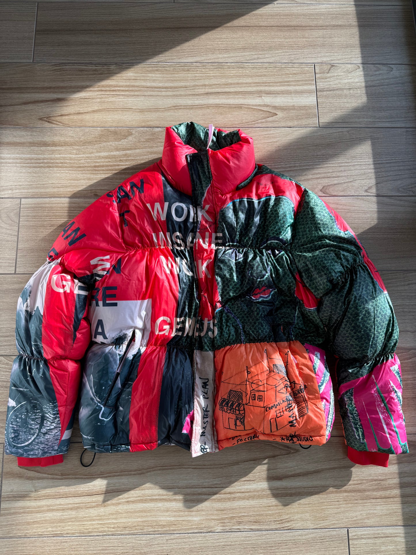 KidSuper Studios “Genius Collage” Puffer Jacket